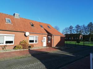 a brick house with a red roof at Piratennest in Osteel