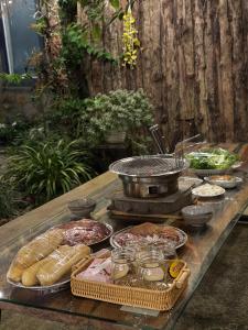 a table with many different types of food on it at Mộc Sơn Homestay in Mộc Châu