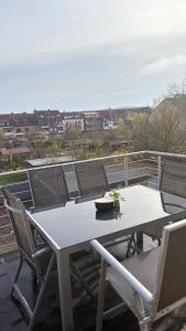 a white table and chairs on a balcony at Vollausgestattetes & harmonisches Wohlfühl Apartment in Saarbrücken