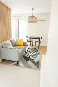 a living room with a couch and a table at Grand Studio entier proche de Tours in Esvres