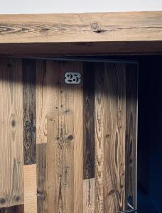 a wooden door with the number on it at Sust Lodge in Hospental
