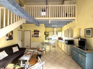 a living room with a couch and a table at Chez castagnet in Assat