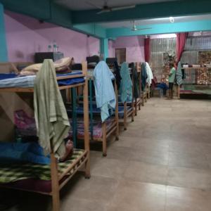 a row of bunk beds in a room at V R S Dormitory in Hubli