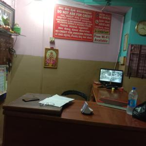 an office with a desk with a phone on it at V R S Dormitory in Hubli