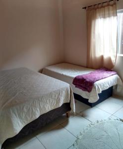 En eller flere senge i et værelse på Hostel da Marcia