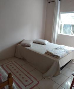 En eller flere senge i et værelse på Hostel da Marcia