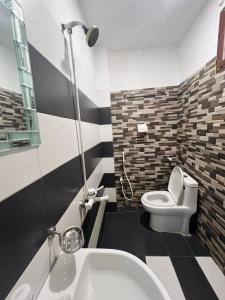 a bathroom with a white toilet and a sink at Karachi Inn PECHS in Karachi +60 photos