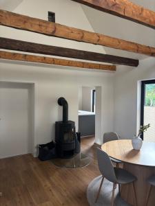 a living room with a wood stove and a table at Albos Ferienhaus zwischen Schlei und Ostseeküste in Fleckeby