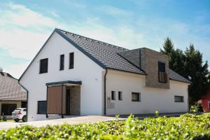 a white house with a black roof at Apartma Ana in Krško
