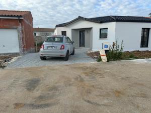 a small silver car parked in front of a house at Petit studio attenant à la maison in Saint-Agnant +3 photos