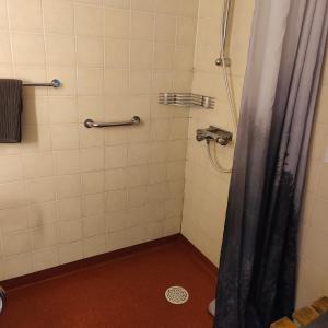 a bathroom with a shower with a black shower curtain at Highway Hotel in Härnösand +32 photos