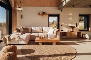 a living room with a couch and a table at Wilcza Villa in Jurgów