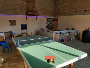 a ping pong table in the middle of a room at Estefana in Chambilly