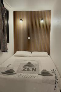 a bed with a sign on it in a room at Cap sur le Lac in Le Barcarès +18 photos