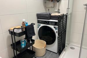eine Waschmaschine in einer Ecke eines Zimmers in der Unterkunft Cozy City Center Designer Apartment for 9 People in Wiener Neustadt