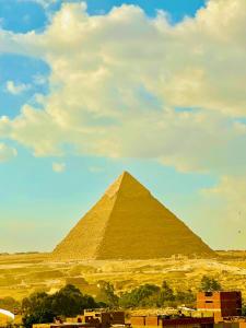 a view of the pyramids of giza on a cloudy day at Energy Pyramids View in Cairo
