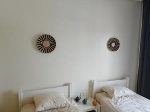 a bedroom with two beds and a mirror on the wall at Apartment in residence CASABAY in Sidi Rahal