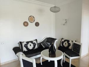 a living room with a couch and a table at Apartment in residence CASABAY in Sidi Rahal