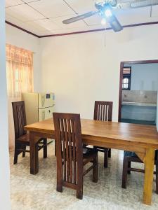 a dining room with a table and four chairs at Coastal breezy bangalow in Weligama