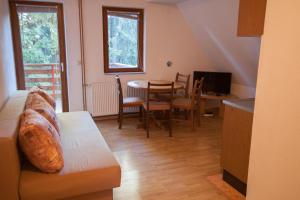 a living room with a couch and a table at Vikend kuća Libertas in Šišava
