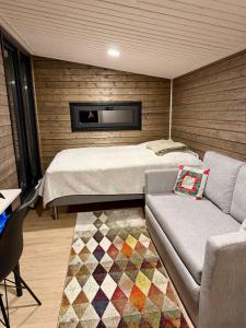a bedroom with a bed and a couch at Willa Haukilahti in Rovaniemi