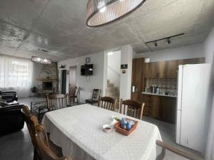 a kitchen and dining room with a table and a refrigerator at Twins Bakuriani in Bakuriani