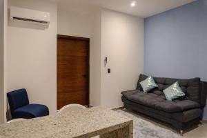 a living room with a couch and a table at Cozy apartment just two blocks from the beach in Isla Venados