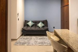 a living room with a couch and a table at Cozy apartment just two blocks from the beach in Isla Venados