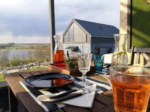 a table with a plate of food and a drink at Strefa Warmia in Wawrowice