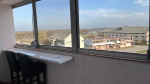 a window with a white counter and a view of a building at Stan na dan Šamac in Bosanski Šamac