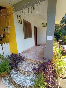 a hallway of a house with plants in front of it at Dhaklos Guest House in Mapusa