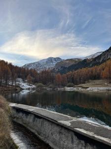a bridge over a river with mountains in the background at Refuge d'hiver de N&M in Tende