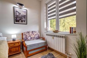 - une chambre avec une chaise et une fenêtre dans l'établissement Forestside Stay at Stream Resort, à Pamporovo