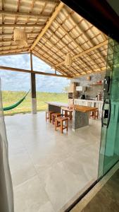 a patio with a table and chairs and a kitchen at Vila Arcanjo in Santana do Riacho