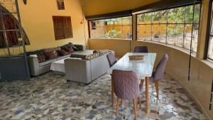 a living room with a couch and a table at Case sauvage in Diana +17 photos