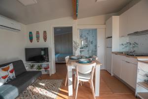 a kitchen and living room with a table and a couch at Balea House in Barreiros