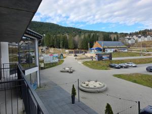 a view of a parking lot with cars in a parking lot at Czarna Perła Apartamenty Czarna Góra 203 in Sienna