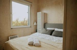 a bedroom with a large bed with towels on it at Strefa Warmia in Wawrowice