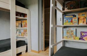a room with two bunk beds with books at Strefa Warmia in Wawrowice