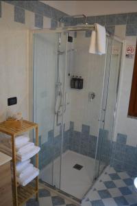a shower with a glass door in a bathroom at Green Hill apartment in Salò +26 photos