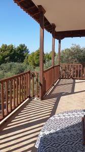 a wooden deck with a bed on it at "STARDUST" Family House in Metamorfosi
