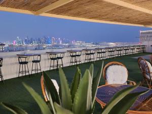 a row of tables and chairs on the roof of a building at Al Safa Royal Suites in Doha