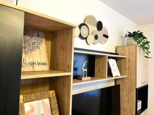 a room with wooden shelves and a fireplace at Rustic Breeze Azuga - BBQ, Fireplace and Parking in Azuga