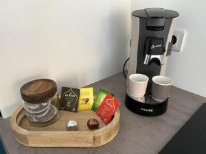 a counter top with a coffee maker and a tray of food at Ateliers des rêves - climatisé, Dijon centre in Dijon