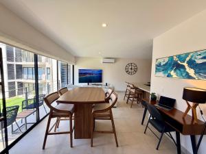 a living room with a table and chairs at Modern Luxury Residency at Altea-Sunset Pool View in Puerto Vallarta