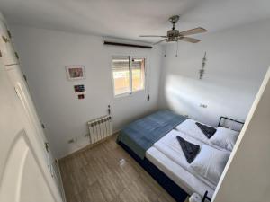 a bedroom with a bed and a ceiling fan at A & G Sabinillas in San Luis de Sabinillas +45 photos