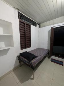 a bench in a room with a window at Haze Munnar Homestay in Anachal