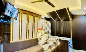 a living room with a couch and a television at Taj 3 Star Hotel Near 200mtr Taj Mahal Agra in Tājganj