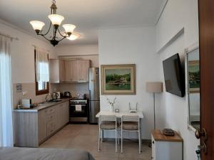 a kitchen with a small table and a kitchen with a sink at "Akrivis studio" in Athens