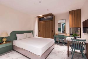 a bedroom with a bed and a desk and a table at Paradise Boutique Hotel Hoàng Cầu in Hanoi